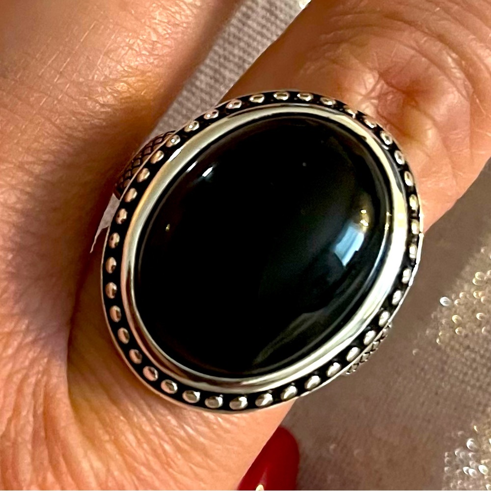 Silver tone and black ring, new, size 8, never used or worn.